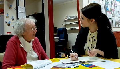 A student volunteering on a project with older people.